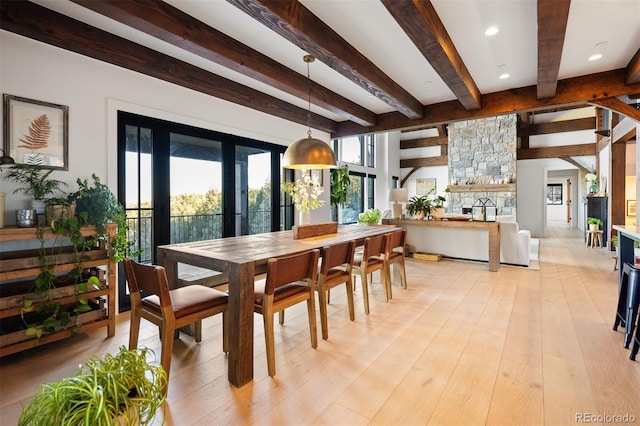 534 W Meadow Rd, Evergreen, CO 80439 - dining space featuring beam ceiling, light wood-style flooring, a stone fireplace, and recessed lighting