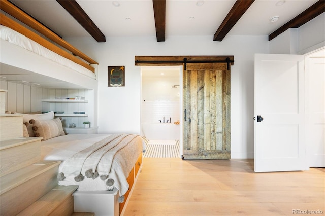 534 W Meadow Rd, Evergreen, CO 80439 - bedroom with beamed ceiling, wood finished floors, and a barn door