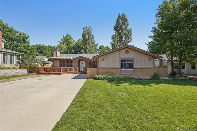 215 Sunland St, Louisville, CO 80027 - single story home featuring brick siding, driveway, a chimney, and a front lawn