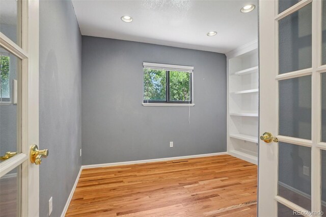 215 Sunland St, Louisville, CO 80027 - spare room featuring wood finished floors, built in features, and recessed lighting