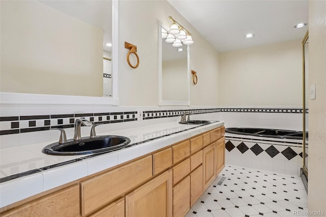 215 Sunland St, Louisville, CO 80027 - bathroom featuring double vanity, a relaxing tiled tub, tile patterned flooring, and recessed lighting