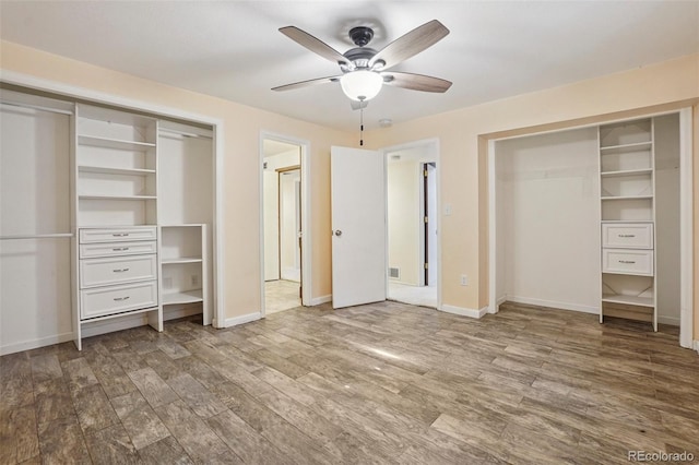 215 Sunland St, Louisville, CO 80027 - unfurnished bedroom with wood finished floors, multiple closets, and ceiling fan
