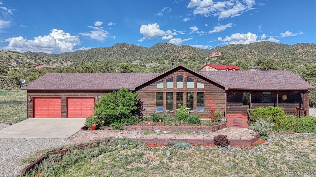 view of front facade with a garage and a mountain view