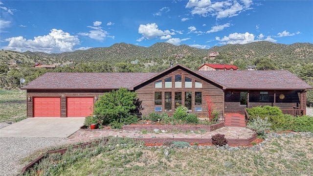 view of front facade with a garage and a mountain view