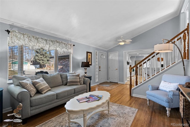 living room with crown molding, wood-type flooring, lofted ceiling, and ceiling fan