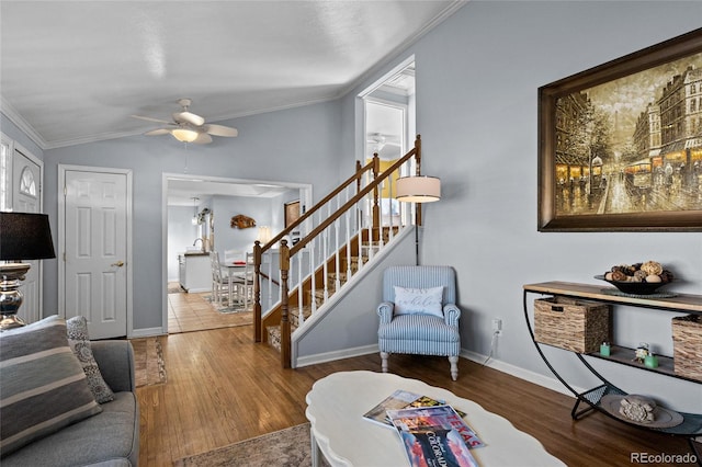 living room with lofted ceiling, hardwood / wood-style flooring, ceiling fan, and crown molding