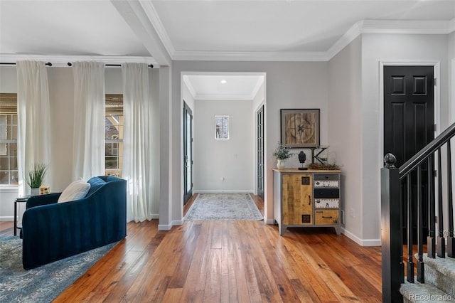 foyer entrance featuring ornamental molding and wood-type flooring