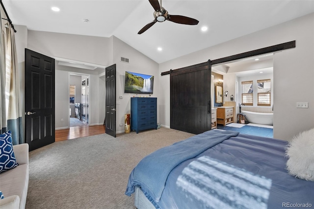 bedroom with ceiling fan, carpet, lofted ceiling, and a barn door