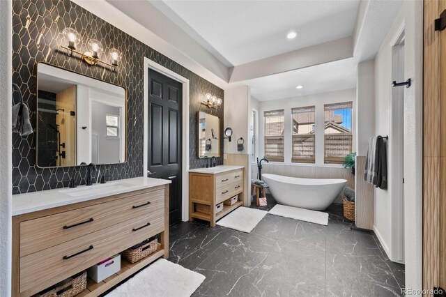 bathroom with vanity and separate shower and tub