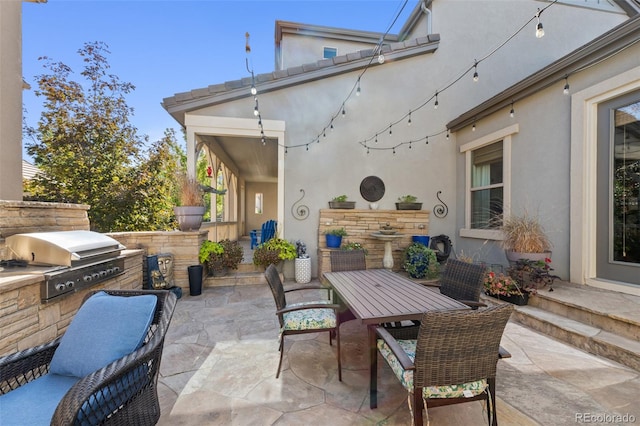 view of patio / terrace featuring an outdoor kitchen and a grill