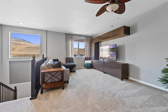 living room featuring ceiling fan and light colored carpet