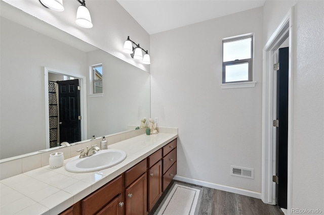 bathroom with vanity and hardwood / wood-style floors