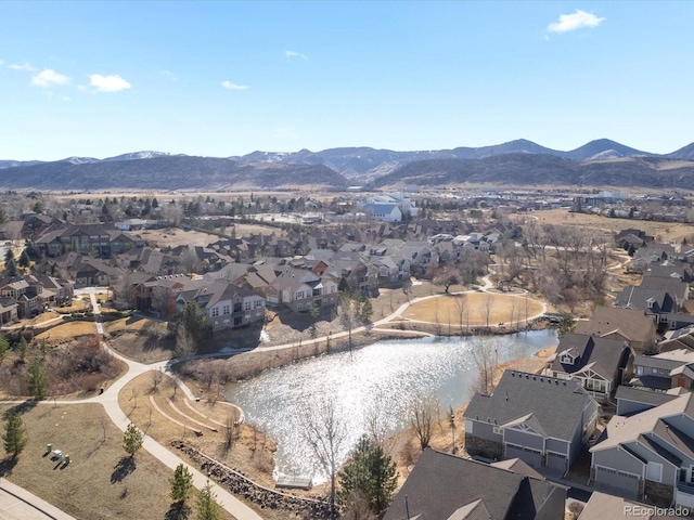 drone / aerial view featuring a residential view and a water and mountain view