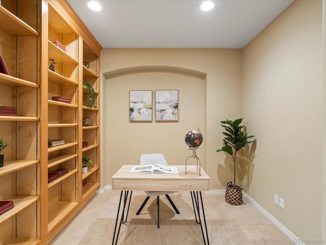 office area featuring arched walkways, recessed lighting, light colored carpet, and baseboards