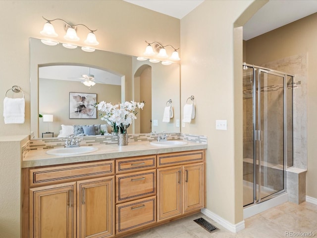 full bathroom with a sink, visible vents, a stall shower, and double vanity