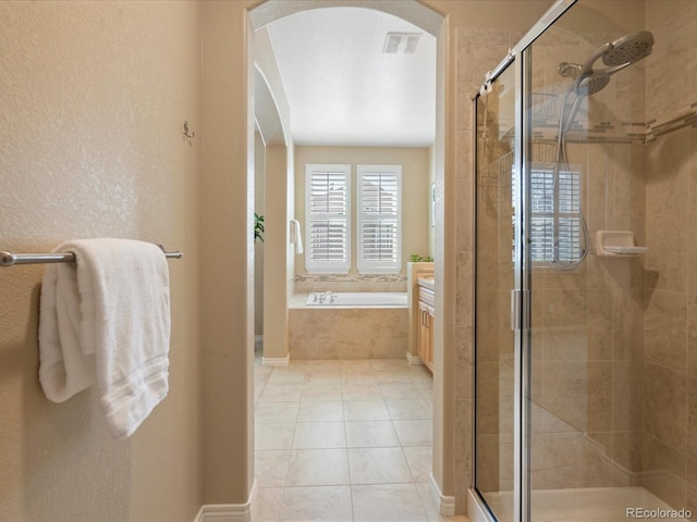 full bath with visible vents, a garden tub, a shower stall, tile patterned flooring, and a textured wall