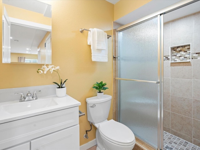 full bath featuring a shower stall, toilet, and vanity