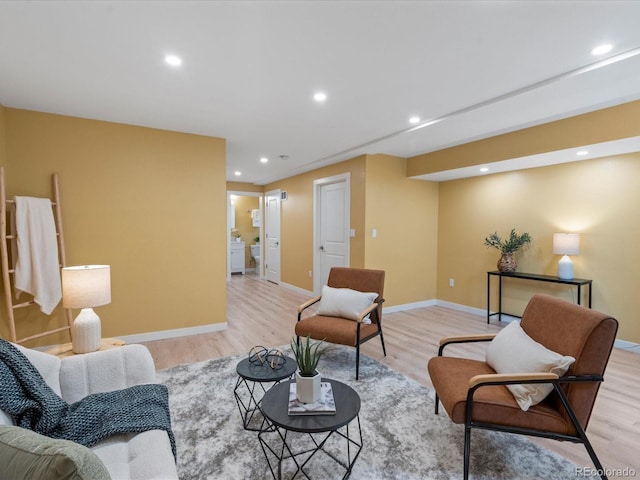 living area with recessed lighting, light wood-type flooring, and baseboards