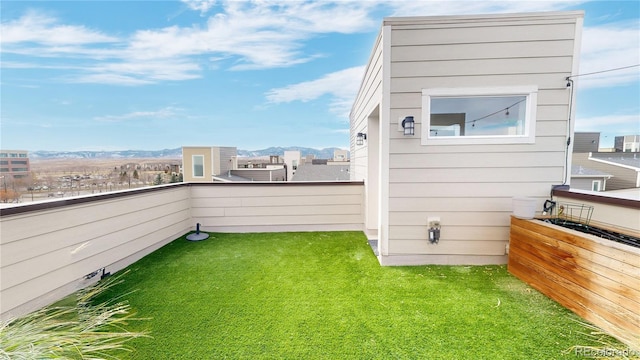 exterior space with a balcony and a mountain view