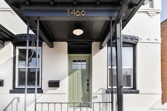 entrance to property with brick siding