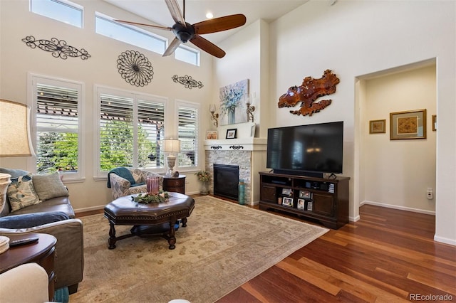 12189 Windy Trail Ln, Parker, CO 80138 - living area with a ceiling fan, wood finished floors, plenty of natural light, a fireplace, and a high ceiling