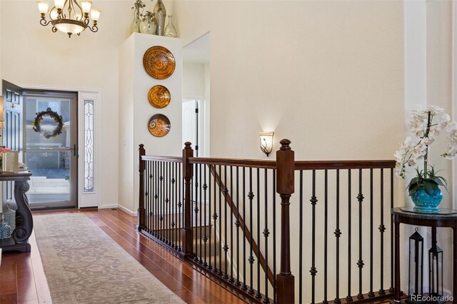 12189 Windy Trail Ln, Parker, CO 80138 - hall with a chandelier, wood finished floors, and a high ceiling