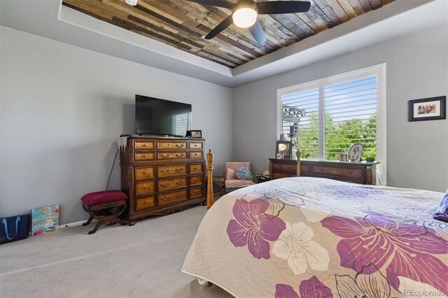 12189 Windy Trail Ln, Parker, CO 80138 - carpeted bedroom featuring a tray ceiling, wood ceiling, ceiling fan, and baseboards