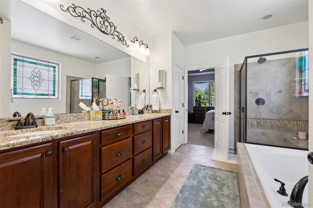 12189 Windy Trail Ln, Parker, CO 80138 - bathroom featuring a stall shower, ensuite bathroom, double vanity, tiled bath, and tile patterned floors