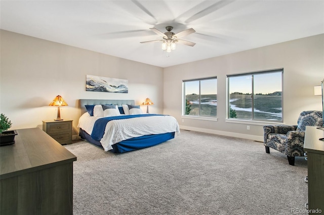 carpeted bedroom featuring baseboards and ceiling fan