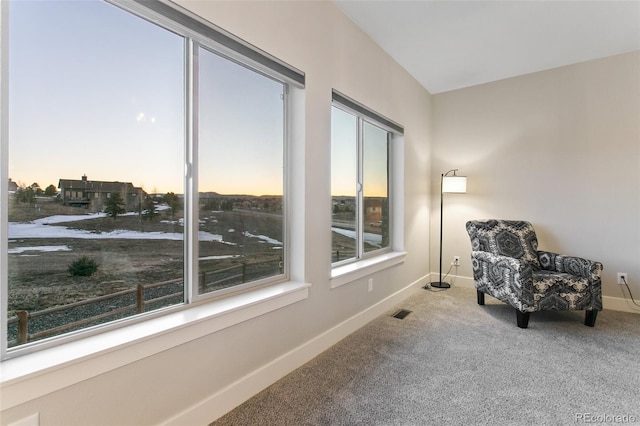 living area with carpet flooring, baseboards, and visible vents