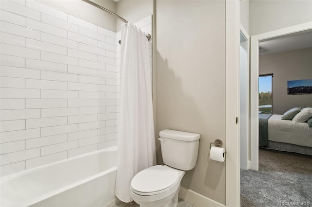 full bathroom with toilet, baseboards, shower / bath combo with shower curtain, and ensuite bathroom