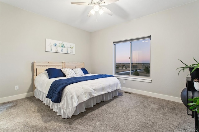 carpeted bedroom featuring visible vents, baseboards, and a ceiling fan