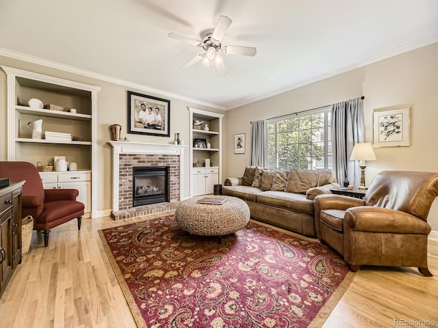 9625 S Hackberry St, Highlands Ranch, CO 80129 - living area featuring built in shelves, ceiling fan, light wood finished floors, ornamental molding, and a brick fireplace