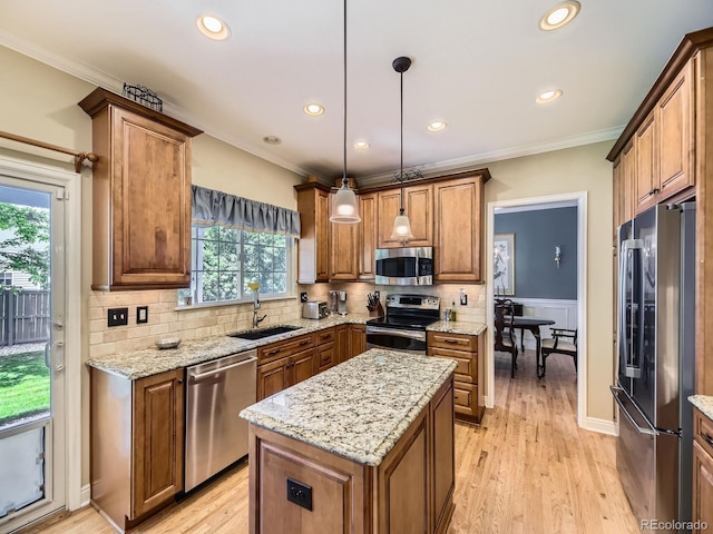9625 S Hackberry St, Highlands Ranch, CO 80129 - kitchen featuring stainless steel appliances, recessed lighting, ornamental molding, brown cabinetry, and tasteful backsplash