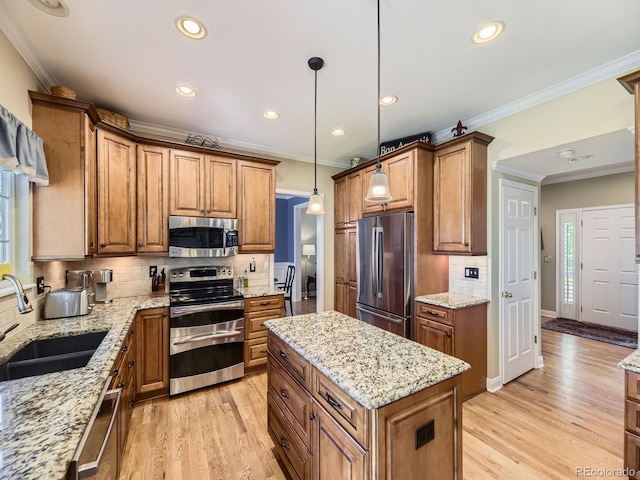 9625 S Hackberry St, Highlands Ranch, CO 80129 - kitchen featuring stainless steel appliances, brown cabinetry, recessed lighting, ornamental molding, and light wood-type flooring