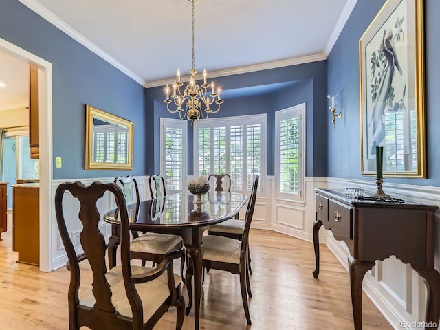 9625 S Hackberry St, Highlands Ranch, CO 80129 - dining space featuring a chandelier, healthy amount of natural light, crown molding, light wood finished floors, and wainscoting