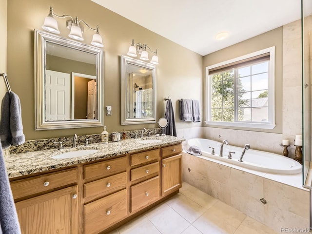 9625 S Hackberry St, Highlands Ranch, CO 80129 - bathroom featuring a garden tub, double vanity, and tile patterned flooring