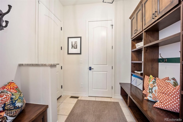 mudroom featuring visible vents, baseboards, and light tile patterned floors