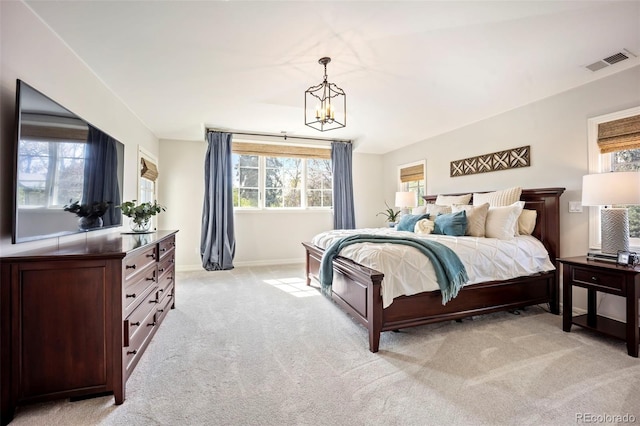 bedroom featuring light colored carpet, a chandelier, visible vents, and multiple windows