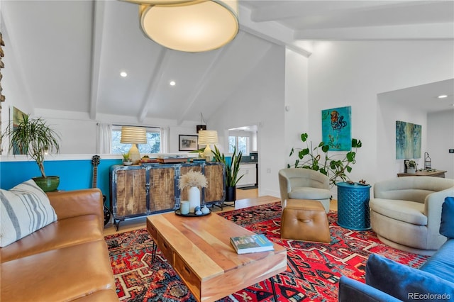 living area with beam ceiling, recessed lighting, high vaulted ceiling, and wood finished floors