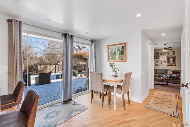 dining room featuring a ceiling fan, recessed lighting, baseboards, and light wood finished floors