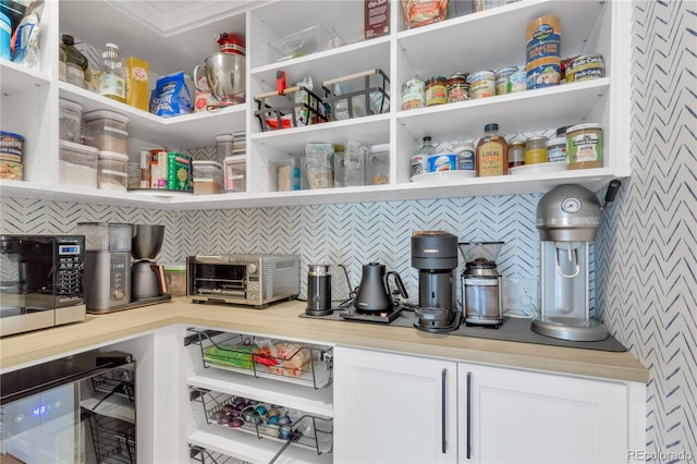 pantry with beverage cooler and a toaster