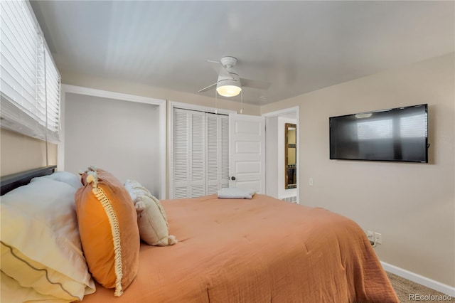 bedroom featuring a closet, baseboards, carpet, and a ceiling fan