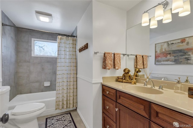 full bathroom with vanity, baseboards, tile patterned flooring, shower / bath combination with curtain, and toilet