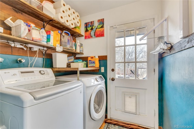 clothes washing area featuring washer and clothes dryer and laundry area