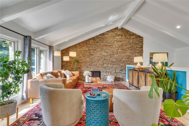 living area featuring lofted ceiling with beams and wood finished floors