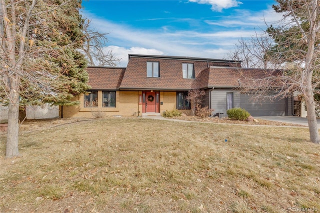 view of front of home with a front yard, driveway, mansard roof, a shingled roof, and a garage