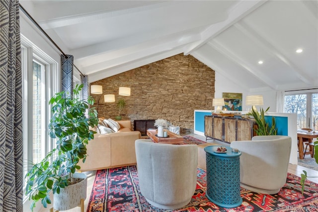 living area featuring lofted ceiling with beams