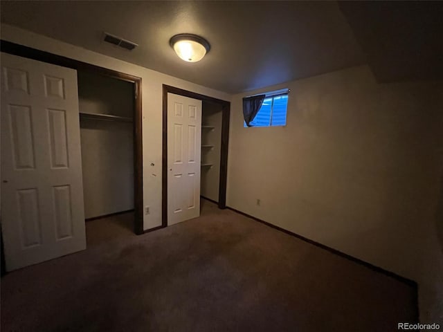 unfurnished bedroom featuring dark colored carpet