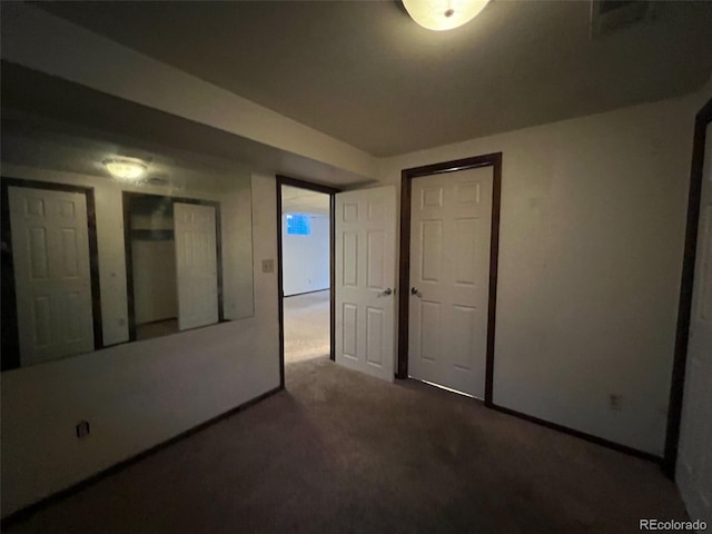 unfurnished bedroom featuring dark carpet